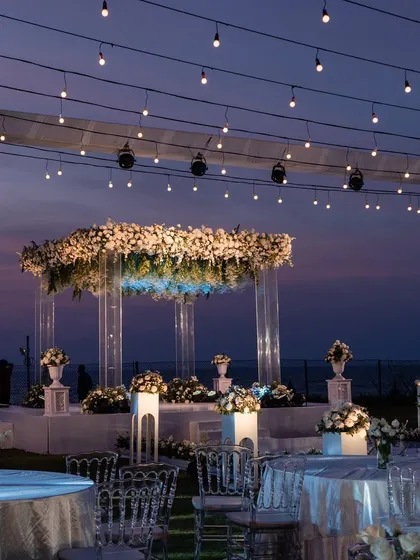 A sundowner vow renewal ceremony in Goa. We used a canopy of fairy lights and a floating floral mandap to create a romantic, fairytale setting against the twilight sky.