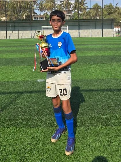 This U14 player holds his trophy after a successful tournament.