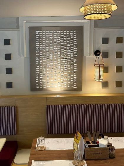 Another view of the textured art wall at Sidewalk, Agra.