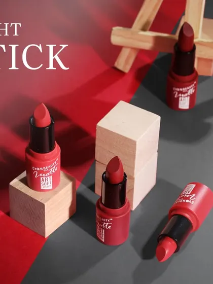 This image showcases a collection of lipsticks arranged with an artist's easel. The creative setup positions the makeup as a tool for artistry, appealing to a creative consumer base.