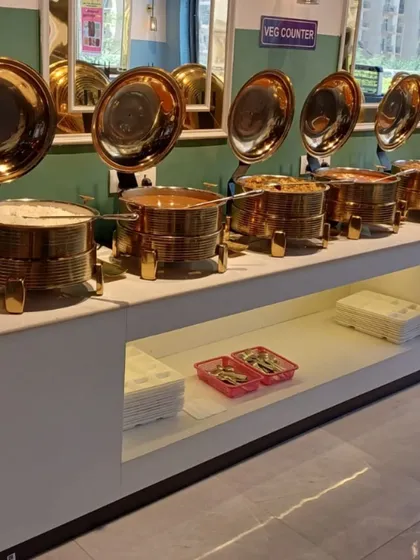 A close-up of our buffet line at the Spectrum Mall location, showcasing the shiny brass chafing dishes that keep the food warm and fresh.