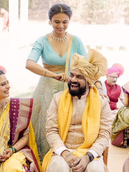 A fun tradition where the bride's sister playfully pulls the groom's ear. The laughter on everyone's faces makes this a cherished, lighthearted memory.