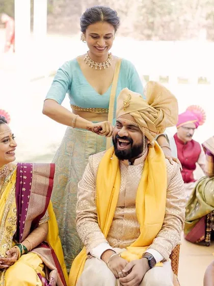 A fun tradition where the bride's sister playfully pulls the groom's ear. The laughter on everyone's faces makes this a cherished, lighthearted memory.