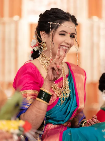 A fun and playful moment! This bride shows her personality while still looking every bit the traditional South Indian queen.