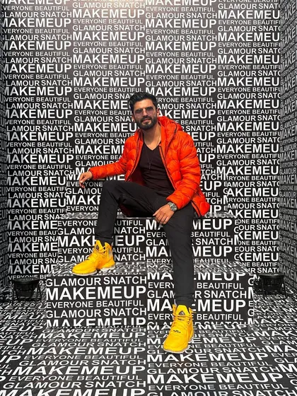 Main character vibes. A bold orange jacket against a graphic background makes for a very modern and pop-art-inspired look.