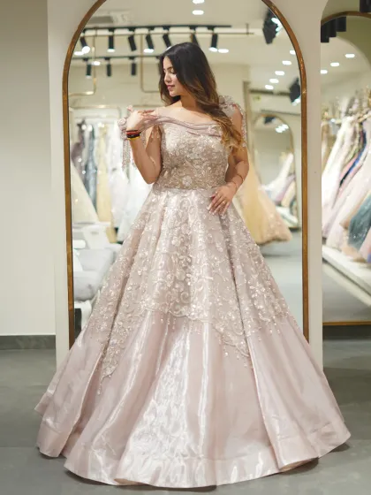 This is the fairytale moment you've been dreaming of. I designed this voluminous ball gown with intricate floral embroidery and a touch of sparkle to make you feel like royalty at any grand reception or engagement.