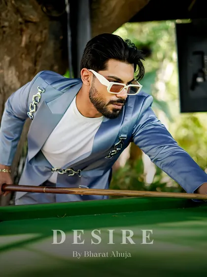 Style and precision, both on and off the pool table. This shot captures the silky sheen and modern detailing of the light blue blazer in a moment of leisure.