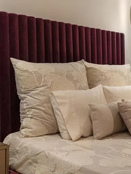 A close-up of the rich, velvet channel-tufted headboard, a perfect example of our detailed upholstery work.