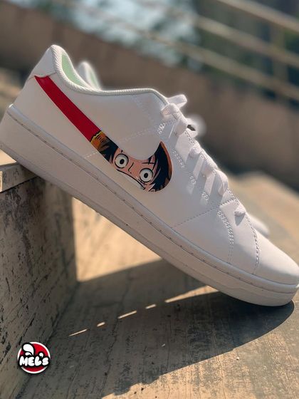 The other side of our One Piece custom Nikes, showing Luffy's face peeking out from behind the swoosh. The clean white sneaker provides the perfect canvas for this detailed anime character art.