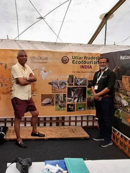 Our team stands proudly in front of a display for Uttar Pradesh Ecotourism at the Global Birdfair. We partner with local governments and organizations to promote responsible tourism.