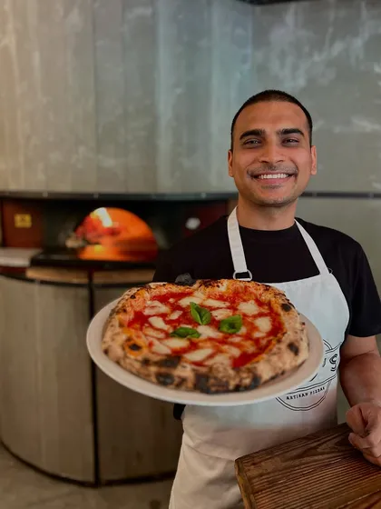 This is me, Amol, with our classic Margherita. It's an honour to be recognized with awards, but seeing you enjoy a slice is what truly makes it all worthwhile.