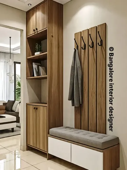 An entryway should be both welcoming and practical. I created this foyer unit to provide a comfortable seating bench with shoe storage below, a tall cabinet for other items, and wall-mounted hooks for coats and bags.