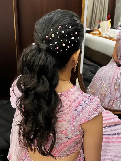 Another view of the pearl-studded ponytail, showing the placement of the accessories to create a starry, scattered effect.