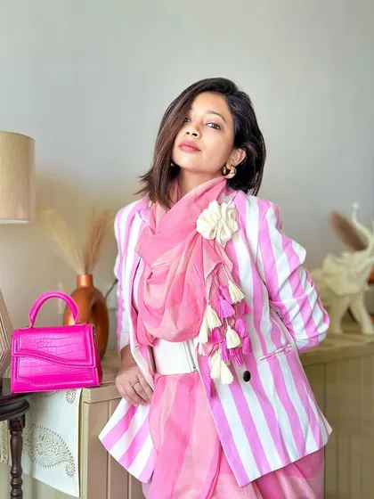 Let's break the rules! I love creating fusion looks, like pairing this beautiful pink striped saree with a matching blazer. It’s a modern, modest, and powerful way to style a saree for a formal event or even for work.