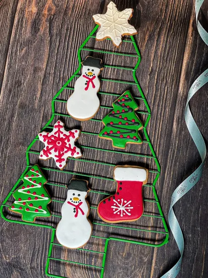 My hand-decorated Christmas cookies are perfect for gifting or hanging on your tree. The set includes snowmen, trees, snowflakes, and stockings.