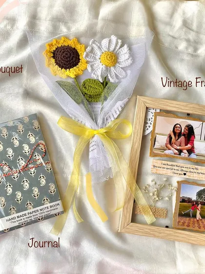 This thoughtful gift set combines a handmade journal with a vintage-style custom photo frame and a sweet sunflower and daisy bouquet.