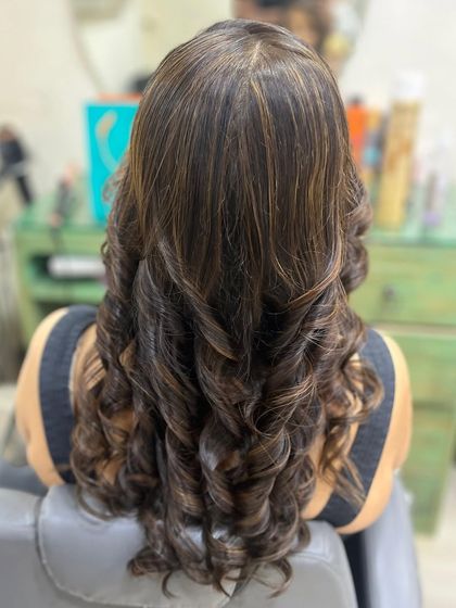 A back view of the golden highlights and curls. You can really see how the light catches the different tones, creating a beautiful, dynamic effect.
