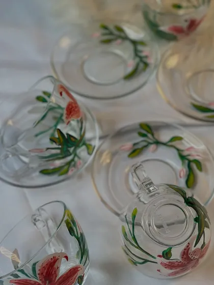 An overhead view of the lily teacup sets, showing how the floral design wraps around both the cup and the saucer.