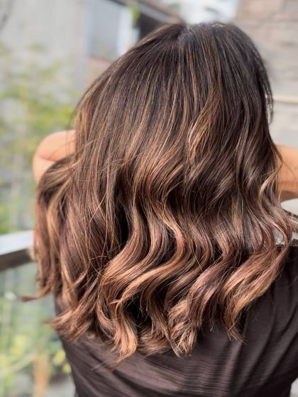 Another angle of the delicious chocolate and caramel balayage, with soft waves that catch the light beautifully. This look is all about radiant, healthy-looking color.