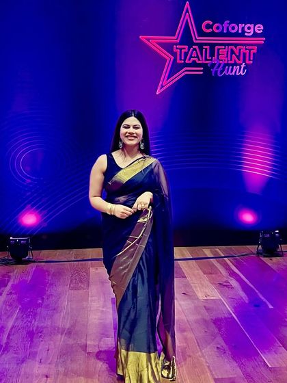 A full-length shot in a classic saree at the Coforge Talent Hunt, showing how I dress to complement the theme and formality of an event.