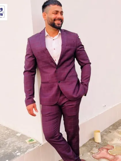 This is what a perfect fit looks like. Our client is wearing a custom-tailored maroon plaid two-piece suit, ideal for both business meetings and evening events. We worked with him to select the fabric and cut for a modern, confident style.