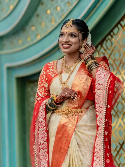 The intricate details of a bridal look, from the jewelry to the saree drape. We ensure the pallu is pleated and set in a way that highlights the blouse work and jewelry.
