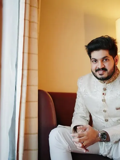 A direct and engaging portrait of the groom. His confident smile and comfortable posture make for a warm and handsome photograph.