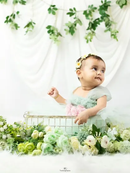 A candid moment from a first birthday shoot, where the baby looks off to the side, creating a beautiful and thoughtful portrait.