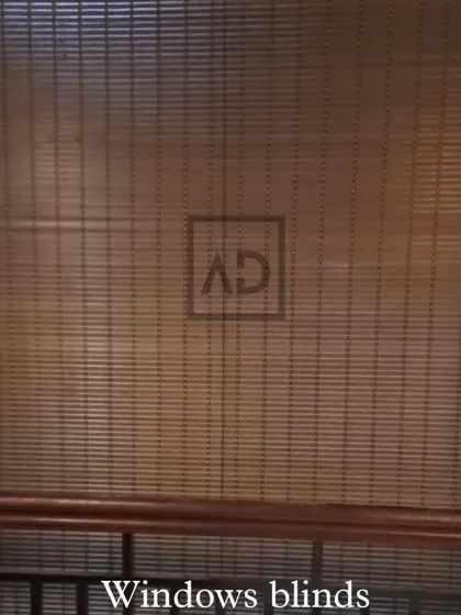A full view of a bamboo roller blind covering a window. This style is perfect for adding a touch of nature indoors and works well in both homes and relaxed commercial settings like cafes or boutiques.