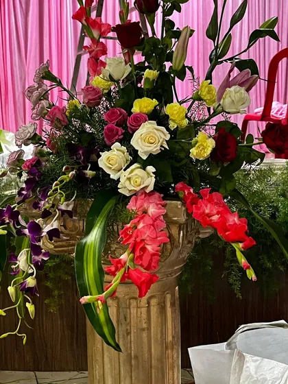 Another look at one of our lush, multi-flower arrangements. The cascading orchids and vibrant gladioli add height and drama, making it a stunning focal point.