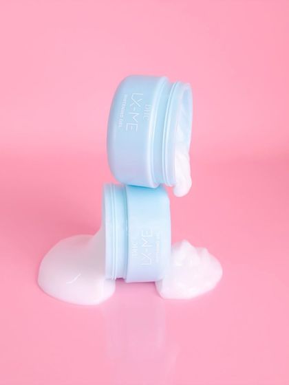 A creative and playful shot with overflowing cream from stacked jars. This dynamic composition for DHC Beauty is eye-catching and emphasizes the product's generous, rich formula.