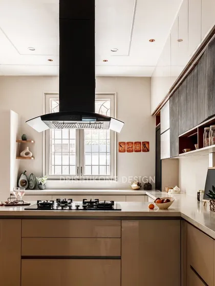 A modern kitchen should be both beautiful and highly functional. We designed this space with handle-less cabinetry for a seamless look, a striking black chimney as a focal point, and ample counter space for easy meal preparation.