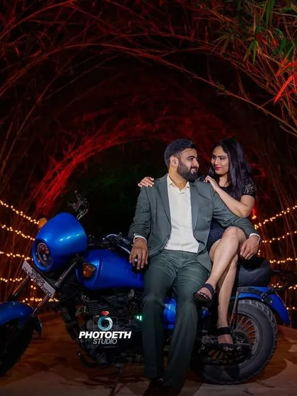 A stylish pre-wedding photo featuring a couple on a motorcycle in a tunnel of lights. This setup is great for creating a cool, edgy, and romantic vibe.