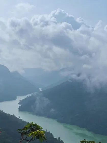 A river flowing through a deep, cloud-filled gorge.