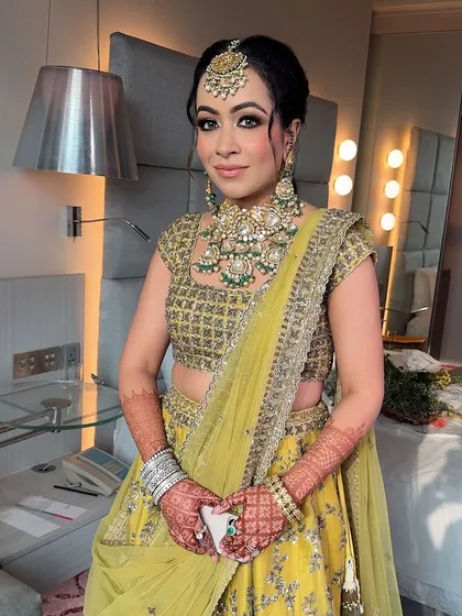 The full look. The soft, golden eye makeup and the glowing skin are a perfect match for her beautiful lime green lehenga.