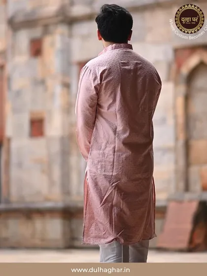A back view of a model in a pink kurta, set against a heritage backdrop. This shows how my outfits are designed to look good from every angle.