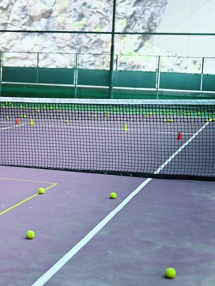 Our indoor tennis court is set up with cones and balls, ready for a session of focused drills and practice.