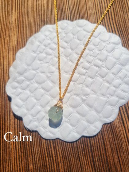 The Aquamarine Melon Pendant, a simple piece that carries the calming energy of the stone.