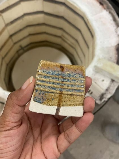 A beautiful result from our glaze testing. This tile shows how different chemicals react to create stunning layered colors and effects.