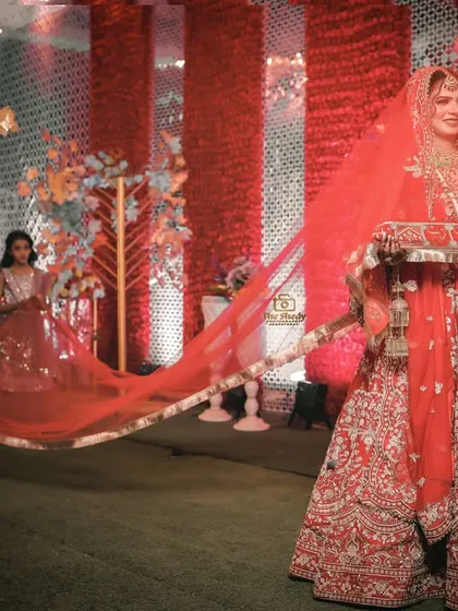 The grand bridal entry. This shot captures the bride Simran making her entrance with a long, flowing veil, creating a moment of pure elegance and tradition.