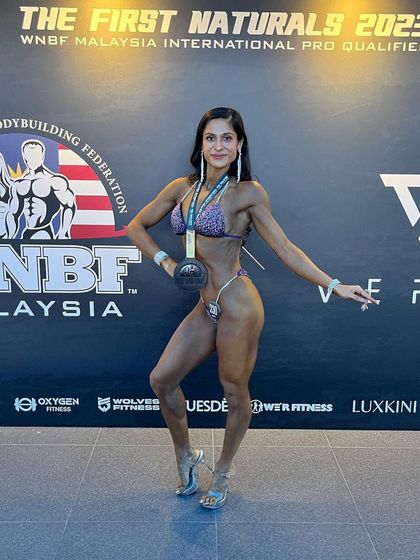 Posing on stage at the WNBF Malaysia International Pro Qualifier. This was my first time competing with WNBF, and it was an incredible experience to be among top natural athletes.