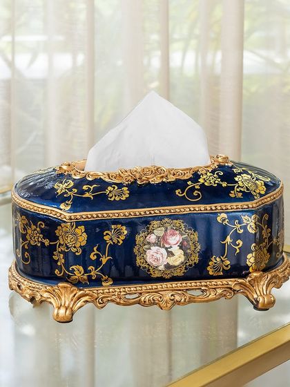 Even everyday items can be luxurious. This Victorian-style tissue box holder, in a deep blue with ornate gold detailing and a floral cameo, elevates a simple utility item into a piece of decor.
