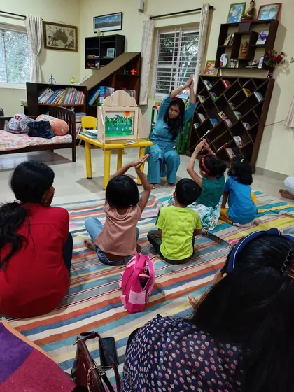 Children do yoga poses to imitate the mountains in the "Bear Hunt" story, an example of how we integrate movement and mindfulness.