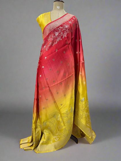 A fiery shaded satin saree blending from red to yellow.