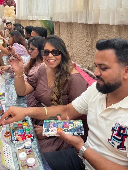 A couple enjoying a creative moment at their baby shower. Painting together is a wonderful way for parents-to-be to celebrate their new beginning.