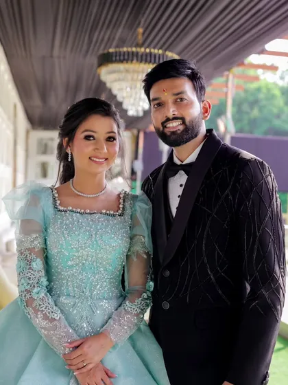A happy portrait of the newly engaged couple. Their bright smiles and elegant outfits perfectly capture the joy and excitement of this special milestone.