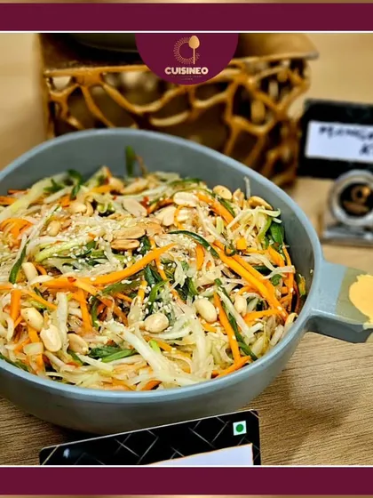 This is my fresh raw papaya salad, a popular choice for healthy and light menus. It combines shredded papaya, carrots, and peanuts, offering a crunchy texture and a zesty flavor that works well as an appetizer or a side dish for any event.