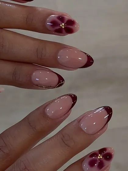 A beautiful and delicate floral design on a French manicure base, showcasing the versatility of blossom gel for creating soft, elegant looks.