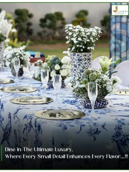 An example of our luxury table decor, this setting features an elegant blue and white printed linen, metallic charger plates, and fresh floral centerpieces for a sophisticated dining experience.