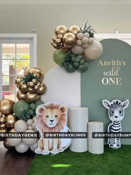 This "Wild One" safari theme features a clean, two-panel backdrop in sage green and white. I used cute lion and zebra cutouts and elegant gold and green balloon clusters to complete the look.